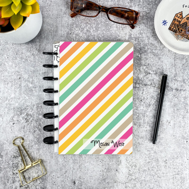Personalized disc bound password book in bright stripes pattern with laminated cover, black discs, and custom name