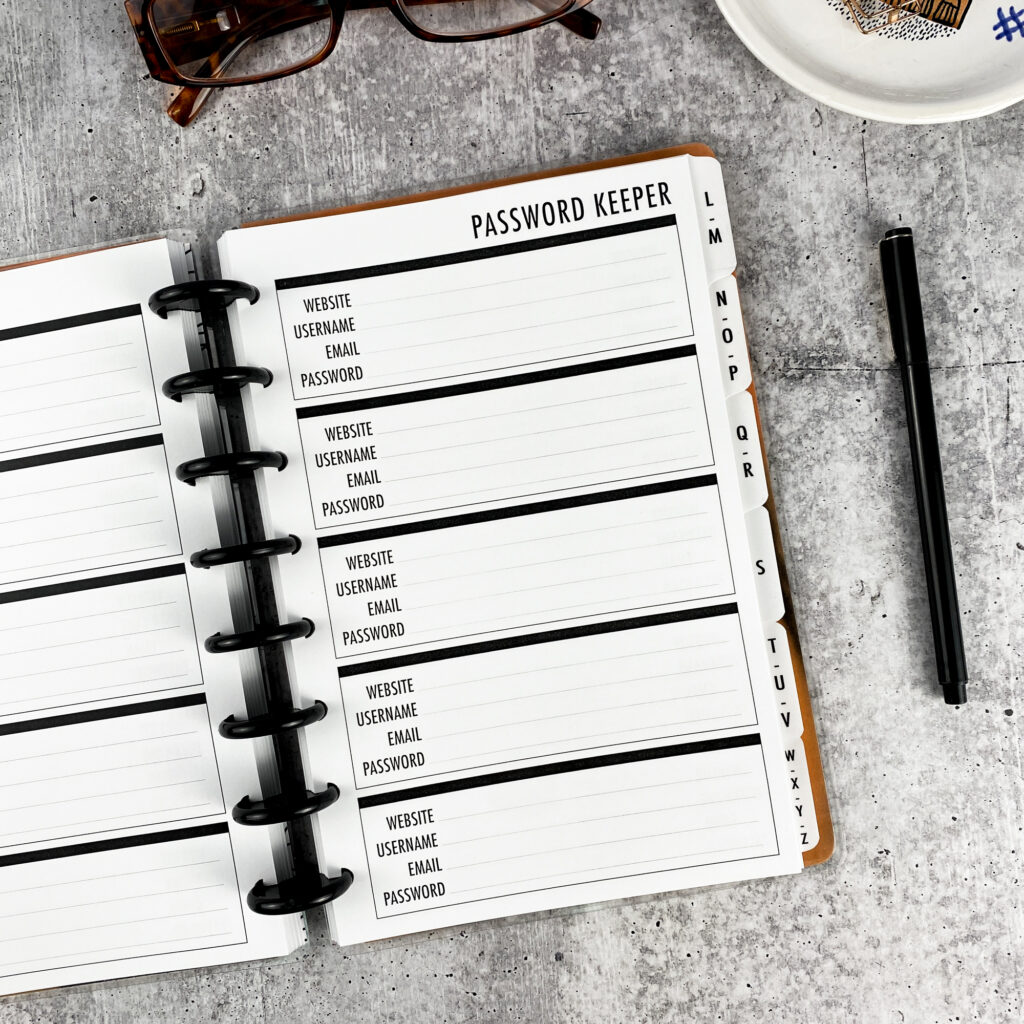Password book cover page with Password Keeper title and security reminder, alphabet tabs along right edge